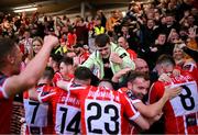 27 July 2023; Derry City players celebrate with supporters after Cian Kavanagh scored their second goal during the UEFA Europa Conference League Second Qualifying Round First Leg match between Derry City and KuPS at the Ryan McBride Brandywell Stadium in Derry. Photo by David Fitzgerald/Sportsfile