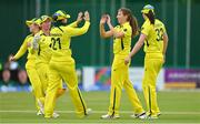 28 July 2023; Australia bowler Darcie Brown, second from right, is congratulated by teammates after claiming the wicket of Ireland's Leah Paul during match three of the Certa Women’s One Day International Challenge series between Ireland and Australia at Castle Avenue Cricket Ground in Dublin. Photo by Seb Daly/Sportsfile
