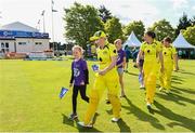 25 July 2023; Australia captain Allyse Perry leads out her team with the mascots before match two of the Certa Women’s One Day International Challenge between Ireland and Australia at Castle Avenue in Dublin. Photo by Sam Barnes/Sportsfile