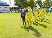 25 July 2023; Australia captain Allyse Perry leads out her team with the mascots before match two of the Certa Women’s One Day International Challenge between Ireland and Australia at Castle Avenue in Dublin. Photo by Sam Barnes/Sportsfile