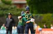 28 July 2023; Ireland batter Orla Prendergast, right, is congratulated by teammate Laura Delany after bringing up her half century of runs during match three of the Certa Women’s One Day International Challenge series between Ireland and Australia at Castle Avenue Cricket Ground in Dublin. Photo by Seb Daly/Sportsfile