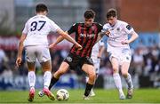 28 July 2023; James Clarke of Bohemians in action against Adam Verdon, left, and Jesse Dempsey of UCD during the SSE Airtricity Men's Premier Division match between Bohemians and UCD at Dalymount Park in Dublin. Photo by Ramsey Cardy/Sportsfile