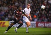 28 July 2023; Jonathan Afolabi of Bohemians in action against  Jack Keaney of UCD during the SSE Airtricity Men's Premier Division match between Bohemians and UCD at Dalymount Park in Dublin. Photo by John Sheridan/Sportsfile