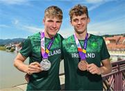29 July 2023; Conor Murphy of Team Ireland, left, with his time trial Silver medal and teammate Cian Crampton with his discus Bronze medal on the Old Bridge in Maribor during day six of the 2023 Summer European Youth Olympic Festival at in Maribor, Slovenia. Photo by Tyler Miller/Sportsfile