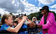 29 July 2023; Rhasidat Adeleke of Tallaght AC, Dublin, right, who recently turned professional, signs autographs for spectators during day one of the 123.ie National Senior Outdoor Championships at Morton Stadium in Dublin. Photo by Sam Barnes/Sportsfile