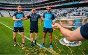 30 July 2023; Dublin players and record 9 time All-Ireland winning medallists, from left, captain James McCarthy, Stephen Cluxton and Michael Fitzsimons celebrate with the Sam Maguire Cup after the GAA Football All-Ireland Senior Championship final match between Dublin and Kerry at Croke Park in Dublin. Photo by Brendan Moran/Sportsfile