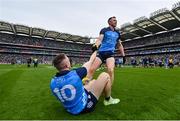 30 July 2023; Paddy Small of Dublin, left, is helped from the floor by teammate Dean Rock after their side's victory in the GAA Football All-Ireland Senior Championship final match between Dublin and Kerry at Croke Park in Dublin. Photo by Seb Daly/Sportsfile