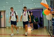 30 July 2023; Time Trial Silver medalist Conor Murphy, left, and Discus Bronze medalist Cian Crampton upon Team Ireland's return to Dublin Aiport from the 2023 Summer European Youth Olympic Festival in Maribor, Slovenia. Photo by Tyler Miller/Sportsfile
