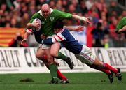 7 March 1998; Keith Wood of Ireland is tackled by Christophe Dominici of France during the Five Nations Rugby Championship match between France and Ireland at the Stade De France in Paris, France. Photo by Brendan Moran/Sportsfile