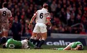 4 April 1998; Eric Elwood, left, and Mark McCall of Ireland lie injured after clashing heads while tackling Laurence Dallaglio of England, 6, during the Five Nations Rugby Championship match between England and Ireland at Twickenham Stadium in London, England. Photo by Brendan Moran/Sportsfile