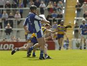 26 June 2004; Joe Fitzpatrick, Laois, is tackled by David Hoey, Clare. Guinness Senior Hurling Championship Qualifier, Round 1, Clare v Laois, Gaelic Grounds, Limerick. Picture credit; Pat Murphy / SPORTSFILE
