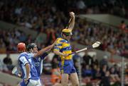 26 June 2004; Tony Griffin, Clare, fields a high ball against Paul Cuddy, Laois, as team-mate Michael McEvoy, 7, awaits the breaking ball. Guinness Senior Hurling Championship Qualifier, Round 1, Clare v Laois, Gaelic Grounds, Limerick. Picture credit; Pat Murphy / SPORTSFILE