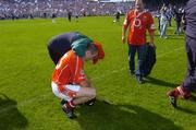 27 June 2004; Cork's Ben O'Connor is consoled by a supporter after defeat to Waterford. Guinness Munster Senior Hurling Championship Final, Cork v Waterford, Semple Stadium, Thurles, Co. Tipperary. Picture credit; Ray McManus / SPORTSFILE