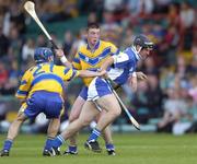 26 June 2004; David Cuddy, Laois, is tackled by Gerry O'Grady, 27, and Diarmuid McMahon, Clare. Guinness Senior Hurling Championship Qualifier, Round 1, Clare v Laois, Gaelic Grounds, Limerick. Picture credit; Ray McManus / SPORTSFILE