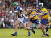 26 June 2004; Damien Culleton, Laois, is tackled by Tomas Holland, right, and Frank Lohan, Clare. Guinness Senior Hurling Championship Qualifier, Round 1, Clare v Laois, Gaelic Grounds, Limerick. Picture credit; Pat Murphy / SPORTSFILE
