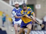 26 June 2004; Gerry Quinn, Clare, in action against Jimmy Dunne, Laois. Guinness Senior Hurling Championship Qualifier, Round 1, Clare v Laois, Gaelic Grounds, Limerick. Picture credit; Ray McManus / SPORTSFILE