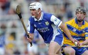 26 June 2004; Liam Tynan, Laois, in action against Niall Gilligan, Clare. Guinness Senior Hurling Championship Qualifier, Round 1, Clare v Laois, Gaelic Grounds, Limerick. Picture credit; Ray McManus / SPORTSFILE