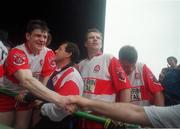 19 September 1993; Enda Gormley is congratulated by a supporter after victory over Cork, as manager Eamonn Coleman and players Tony Scullion and Anthony Tohill, right,  await the presentation. All-Ireland Football Championship Final, Derry v Cork, Croke Park, Dublin. Picture credit; Ray McManus / SPORTSFILE