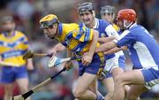 26 June 2004; Tony Griffin, Clare, in action against Michael McEvoy, and Paul Cuddy, back, Laois. Guinness Senior Hurling Championship Qualifier, Round 1, Clare v Laois, Gaelic Grounds, Limerick. Picture credit; Ray McManus / SPORTSFILE