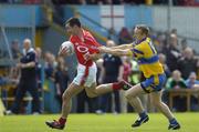 3 July 2004; Dermot Hurley, Cork, in action against Noel Griffin, Clare. Bank of Ireland Football Championship Qualifier, Round 2, Clare v Cork, Cusack Park, Ennis, Co. Clare. Picture credit; Ray McManus / SPORTSFILE