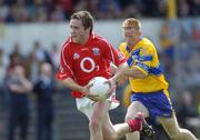 3 July 2004; Alan Cronin, Cork, in action against Ronan Slattery, Clare. Bank of Ireland Football Championship Qualifier, Round 2, Clare v Cork, Cusack Park, Ennis, Co. Clare. Picture credit; Ray McManus / SPORTSFILE