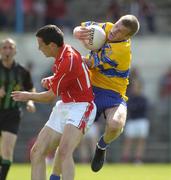 3 July 2004; Ger Quinlan, Clare, is tackled by Michael O'Sullivan, Cork. Bank of Ireland Football Championship Qualifier, Round 2, Clare v Cork, Cusack Park, Ennis, Co. Clare. Picture credit; Ray McManus / SPORTSFILE