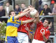 3 July 2004; Derek Kavanagh, Cork, wins possession ahead of his team-mate Martin Cronin and Clare's David Russell. Cork, Bank of Ireland Football Championship Qualifier, Round 2, Clare v Cork, Cusack Park, Ennis, Co. Clare. Picture credit; Ray McManus / SPORTSFILE