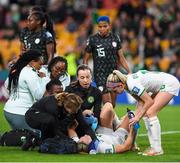 31 July 2023; Kyra Carusa of Republic of Ireland receieves medical attention after a collision with Nigeria goalkeeper Chiamaka Nnadozie during the FIFA Women's World Cup 2023 Group B match between Republic of Ireland and Nigeria at Brisbane Stadium in Brisbane, Australia. Photo by Mick O'Shea/Sportsfile