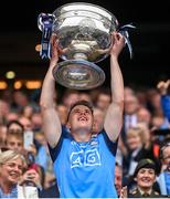 30 July 2023; Daire Newcombe of Dublin lifts the Sam Maguire Cup after the GAA Football All-Ireland Senior Championship final match between Dublin and Kerry at Croke Park in Dublin. Photo by Ramsey Cardy/Sportsfile