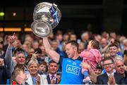 30 July 2023; Dean Rock of Dublin, with his daughter Sadie, lifts the Sam Maguire Cup after the GAA Football All-Ireland Senior Championship final match between Dublin and Kerry at Croke Park in Dublin. Photo by Ramsey Cardy/Sportsfile
