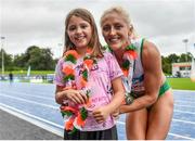 30 July 2023; Women's 100m hurdles and 100m gold medallist Sarah Lavin, right with Daisy Ryals, aged 8, from Celbridge, Kildare, during day two of the 123.ie National Senior Outdoor Championships at Morton Stadium in Dublin. Photo by Sam Barnes/Sportsfile