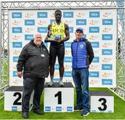 30 July 2023; Israel Olatunde of UCD AC, Dublin, is presented with the Paddy Larkin Memorial Trophy by Athletics Ireland President John Cronin and Adrian Curley of Tullamore Harriers after winning the men's 100m during day two of the 123.ie National Senior Outdoor Championships at Morton Stadium in Dublin. Photo by Sam Barnes/Sportsfile