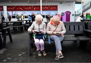 31 July 2023; Racegoers Stephenie, left, and Marie O'Connell from Mallow, Cork study the form during day one of the Galway Races Summer Festival at Ballybrit Racecourse in Galway. Photo by David Fitzgerald/Sportsfile