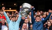 30 July 2023; Dublin players Ben Millist, left, and Liam Smith lift the Sam Maguire Cup after the GAA Football All-Ireland Senior Championship final match between Dublin and Kerry at Croke Park in Dublin. Photo by Ramsey Cardy/Sportsfile