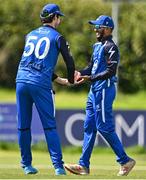 1 August 2023; Amish Sidhu of Leinster Lightning, right, celebrates with team-mate George Dockrell after catching out Peter Moor of Munster Reds during the Rario Inter-Provincial Trophy 2023 match between Leinster Lightning and Munster Reds at Pembroke Cricket Club in Dublin. Photo by Sam Barnes/Sportsfile