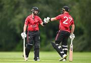 1 August 2023; Tyrone Kane of Munster Reds, left, and team-mate Alistair Frost bump fists during the Rario Inter-Provincial Trophy 2023 match between Leinster Lightning and Munster Reds at Pembroke Cricket Club in Dublin. Photo by Sam Barnes/Sportsfile