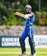 1 August 2023; Riley Mudford of Leinster Lightning holds his bat aloft after bringing hup his half century of runs during the Rario Inter-Provincial Trophy 2023 match between Leinster Lightning and Munster Reds at Pembroke Cricket Club in Dublin. Photo by Sam Barnes/Sportsfile