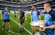 30 July 2023; Dublin nine time All-Ireland medal winners, from left, Michael Fitzsimons, Stephen Cluxton and James McCarthy with teammate Lee Gannon and the Sam Maguire Cup after the GAA Football All-Ireland Senior Championship final match between Dublin and Kerry at Croke Park in Dublin. Photo by Brendan Moran/Sportsfile