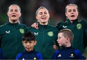 31 July 2023; Republic of Ireland players, from left, Kyra Carusa, Sinead Farrelly and Heather Payne sing Amhrán na bhFiann before the FIFA Women's World Cup 2023 Group B match between Republic of Ireland and Nigeria at Brisbane Stadium in Brisbane, Australia. Photo by Stephen McCarthy/Sportsfile