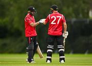 3 August 2023; Tyrone Kane of Munster Reds, left, and team-mate Alistair Frost bump fists during the Rario Inter-Provincial Trophy 2023 match between North West Warriors and Munster Reds at Pembroke Cricket Club in Dublin. Photo by Sam Barnes/Sportsfile
