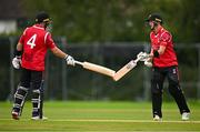 3 August 2023; Alistair Frost of Munster Reds, right, and team-mate Tyrone Kane touch bats during the Rario Inter-Provincial Trophy 2023 match between North West Warriors and Munster Reds at Pembroke Cricket Club in Dublin. Photo by Sam Barnes/Sportsfile
