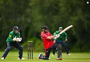 3 August 2023; Tyrone Kane of Munster Reds hits a six watched by North West Warriors wicketkeeper Stephen Doheny during the Rario Inter-Provincial Trophy 2023 match between North West Warriors and Munster Reds at Pembroke Cricket Club in Dublin. Photo by Sam Barnes/Sportsfile