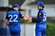 3 August 2023; George Dockrell of Leinster Lightning, right, celebrates with team-mate Fionn Hand after catching out Paul Stirling of Northern Knights during the Rario Inter-Provincial Trophy 2023 match between Leinster Lightning and Northern Knights at Pembroke Cricket Club in Dublin. Photo by Sam Barnes/Sportsfile