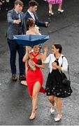 3 August 2023; Racegoers shelter from the rain during day four of the Galway Races Summer Festival at Ballybrit Racecourse in Galway. Photo by Seb Daly/Sportsfile