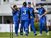 3 August 2023; Simi Singh of Leinster Lightning, left,  celebrates with tream-mates after bowling Ruhan Pretorius of Northern Knights during the Rario Inter-Provincial Trophy 2023 match between Leinster Lightning and Northern Knights at Pembroke Cricket Club in Dublin. Photo by Sam Barnes/Sportsfile