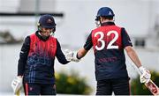 3 August 2023; Neil Rock of Northern Knights, left,  and team-mate Mark Adair bump fists during the Rario Inter-Provincial Trophy 2023 match between Leinster Lightning and Northern Knights at Pembroke Cricket Club in Dublin. Photo by Sam Barnes/Sportsfile