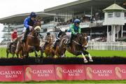 3 August 2023; The Big Doyen, left, with Kevin Sexton up, jumps the first on their way to winning the Guinness Novice Hurdle, from eventual second place What Path, right, with Paul Townend up, during day four of the Galway Races Summer Festival at Ballybrit Racecourse in Galway. Photo by Seb Daly/Sportsfile