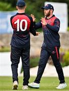 3 August 2023; Ross Adair of Northern Knights,  right, celebrates with team-mate Matthew Humprhies  after catching out Riley Mudford of Leinster Lightning during the Rario Inter-Provincial Trophy 2023 match between Leinster Lightning and Northern Knights at Pembroke Cricket Club in Dublin. Photo by Sam Barnes/Sportsfile
