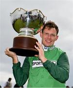 3 August 2023; Jockey Paul Townend celebrates with the trophy after winning the Guinness Galway Hurdle Handicap on Zarak The Brave during day four of the Galway Races Summer Festival at Ballybrit Racecourse in Galway. Photo by Seb Daly/Sportsfile