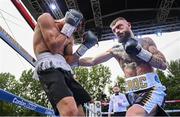 4 August 2023; Lewis Crocker, right, and Greyvin Mendoza during their welterweight bout during the Féile Fight Night at Falls Park in Belfast. Photo by Ramsey Cardy/Sportsfile